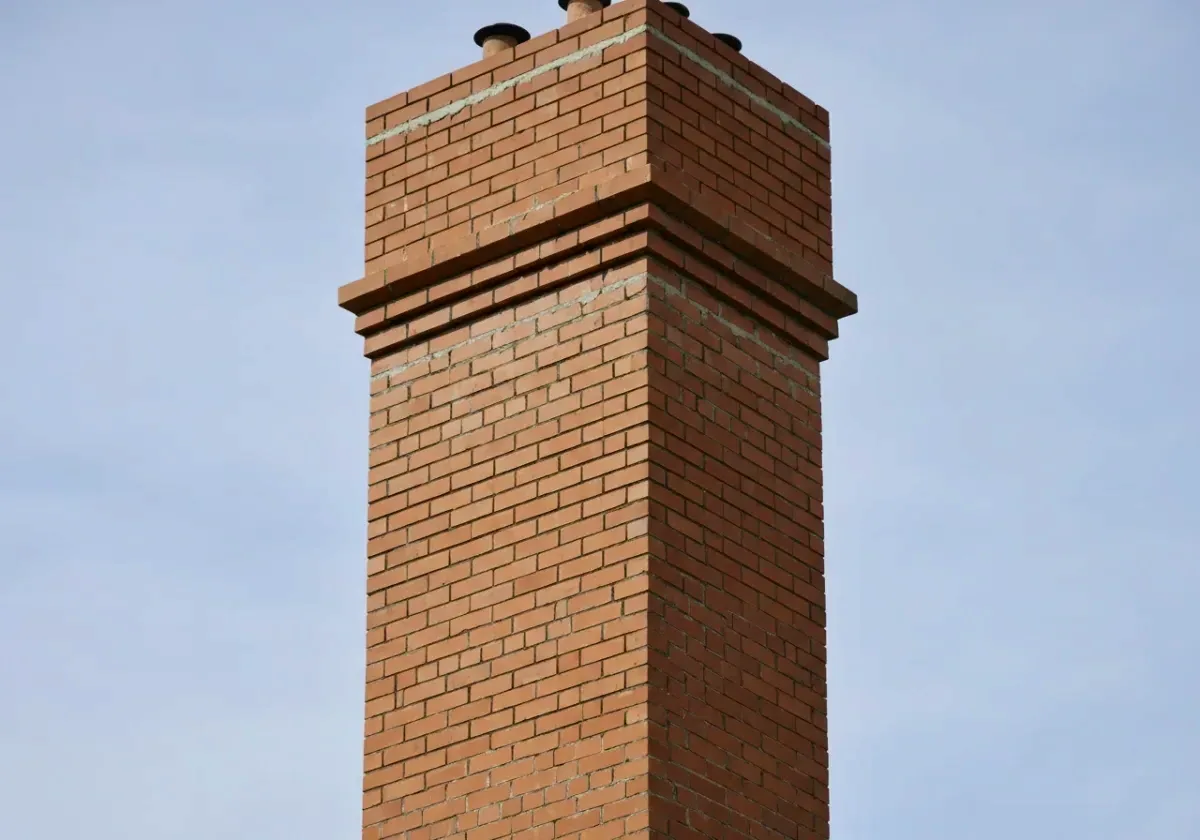 After — chimney repair: Flaking brick and washed-out mortar brought back to a solid, weather-tight stack.